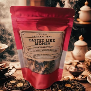 May include: A pink pouch of "Magickal Teas" labeled "Tastes Like Money." The tea blend includes peppermint, black tea, orange peel, cinnamon, ginger root, and clove. The image shows tea leaves in small bowls and steam rising from the pouch.