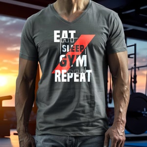 May include: Gray V-neck t-shirt with the text "EAT SLEEP GYM REPEAT" in white, overlaid by a red diagonal stripe. The shirt is made of a soft material and is suitable for gym workouts.
