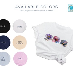 Chart that says Available Colors on top with Country Breeze Studio logo on upper right corner. Labelled circles of colors are: black, white, navy, soft cream, light blue and lilac. Laid out white tshirt shows the design of three flowers on chest area