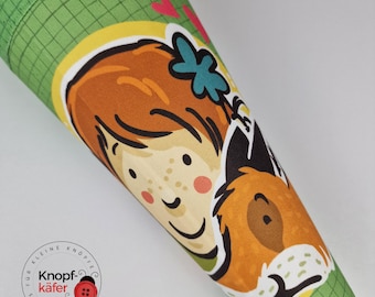 May include: A green and yellow fabric cone with a girl and a fox illustration. The girl has red hair and freckles. The fox is orange and brown. The cone has a green grid pattern and the text "Für kleine Knöpfe - Genähte Käfer" in a circle.