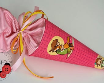 May include: A pink fabric school cone with a grid pattern and illustrations of a girl. The cone is tied with pink, yellow, and orange ribbons. The interior is lined with pink and white striped fabric.