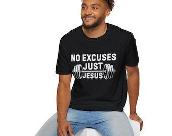 May include: Black t-shirt with the text "NO EXCUSES JUST JESUS" in white, along with a barbell graphic. The shirt is worn by a person in blue jeans.