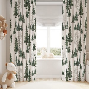 May include: Floor-length curtains featuring a repeating watercolour-style forest pattern with dark green pine trees and bare grey trees on a cream-coloured background. The fabric hangs in vertical folds, covering the sides of a window.