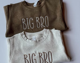 May include: Two sweatshirts, one brown and one beige, with the text "BIG BRO" embroidered on the front.
