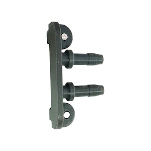 May include: A dark gray plastic connector with two protruding nozzles and a mounting bracket. The connector has a rectangular body with rounded edges and a small hole for mounting.