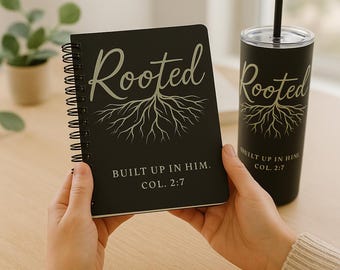 May include: Black spiral-bound notebook and tumbler with the word "Rooted" and a tree root design in a light color. The notebook and tumbler also have the text "BUILT UP IN HIM. COL. 2:7".