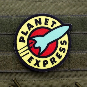 May include: A yellow and black circular patch with the text "Planet Express" and a red circle with a blue spaceship inside.