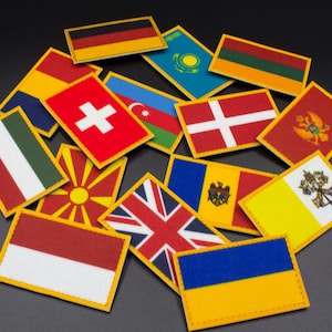 May include: A collection of small, colourful flags with yellow borders, representing different countries. The flags are arranged in a random pattern on a black background.