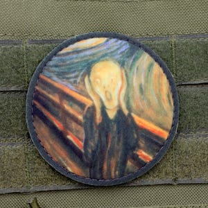 May include: A round patch with a colorful image of Edvard Munch's "The Scream". The patch is made of fabric and has a black border.