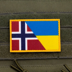 May include: A rectangular patch with a combined flag design. The left side shows the Norwegian flag, with a blue cross on a white background over a red field. The right side shows the Ukrainian flag, with blue over yellow.