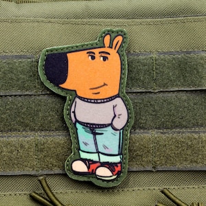 May include: A cartoon dog wearing a gray sweater and blue jeans with red sneakers. The dog is standing on a green background.