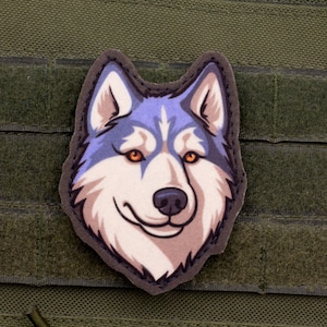 May include: A smiling husky dog patch with a blue and white face, orange eyes, and a black nose. The patch is outlined in dark gray and is set against a green background with velcro straps.
