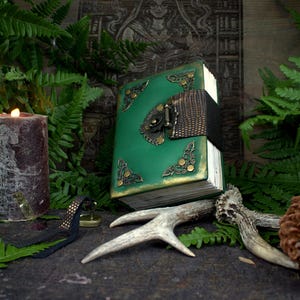 Green leather diary with lock and key, handwritten book with blank pages