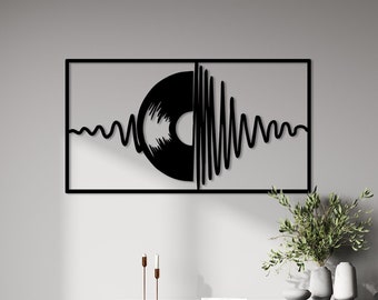 May include: Black metal wall art featuring a stylized record and sound waves. The art is framed in a black metal frame and is hanging on a white wall.