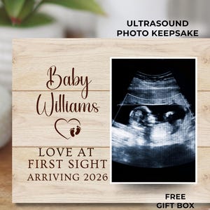 May include: Wooden ultrasound photo keepsake with the text "Baby Williams" and "Love at First Sight Arriving 2026." Includes a framed ultrasound image and the words "Ultrasound Photo Keepsake."