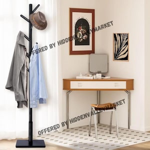 May include: Black metal coat rack with multiple branches for hanging clothes and hats. The rack has a wide base and stands on a tiled floor. A hat is hanging on one of the branches.