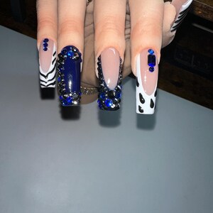 Medium to Long Press On nails with beautiful designs and rhinestones.
