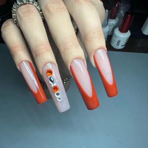 Long Tapered Square Acrylic Press On Nails with a burnt orange French tip design and beautiful high quality rhinestones.