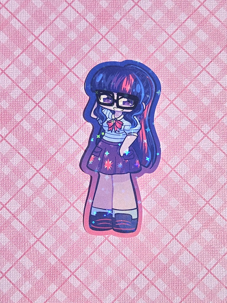 May include: A sticker featuring a cartoon character with dark blue hair, glasses, and a purple skirt adorned with stars. The character wears a white shirt with a blue striped top and a pink bow. The sticker is set against a pink checkered background.
