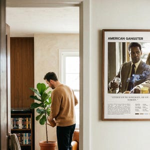 American Gangster poster, Light edition, framed and seen through a doorway from the hall