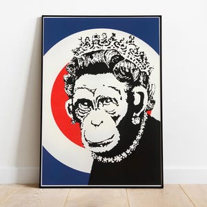 May include: Black and white print of a monkey wearing a crown and a necklace, with a red, white, and blue target behind it.