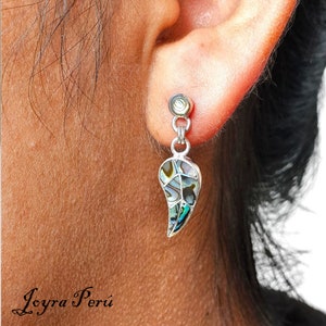 May include: Silver dangle earrings with a teardrop-shaped abalone shell pendant. The shell has a green, blue, and white iridescent pattern.