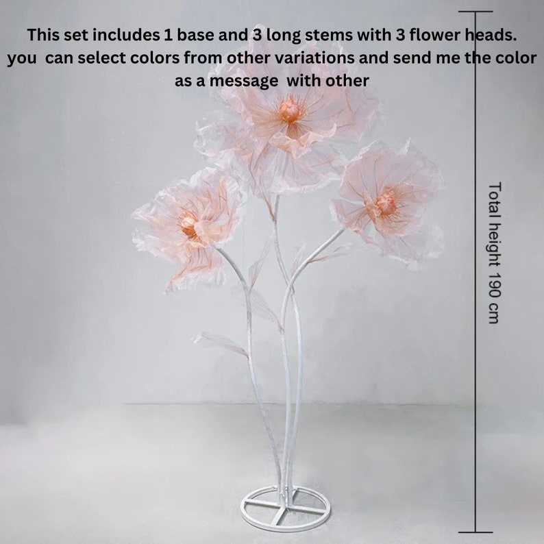 Puede incluir: Un soporte para flores de metal blanco con tres grandes flores de papel rosa. El soporte tiene 190 cm de altura. Este conjunto incluye 1 base y 3 tallos largos con 3 cabezales de flores. Puedes seleccionar colores de otras variaciones y enviarme el color como mensaje con otros.