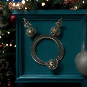 May include: A silver necklace with a circular pendant and two matching earrings. The pendant and earrings are decorated with small holes.