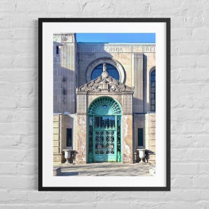 May include: Architectural photograph of a building with a teal-colored door and ornate detailing. The building has a stone facade with the word "PHILOSOPHIA" above the entrance. The door features intricate metalwork and is framed by marble.