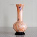 vintage spatter glass vase, made in Japan, orange with blue inclusions and black foot
