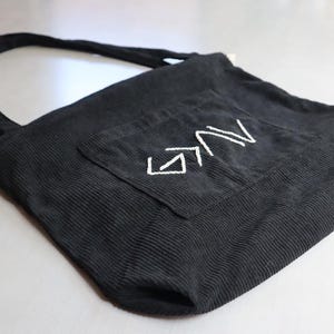 Unique handmade Christian corduroy tote bag embroidered with the phrase “God is Greater Than the Highs and Lows,” symbolizing strength and faith. Features a large outer pocket, zipper closure, and multi-pocket interior for organizing Bibles, journals, or personal items. Perfect for church, Bible study, or everyday wear. A meaningful Christian gift for women rooted in faith and perseverance. Baptism Gift Girl Sewn ToteBag For Car Travel Tote For Christian