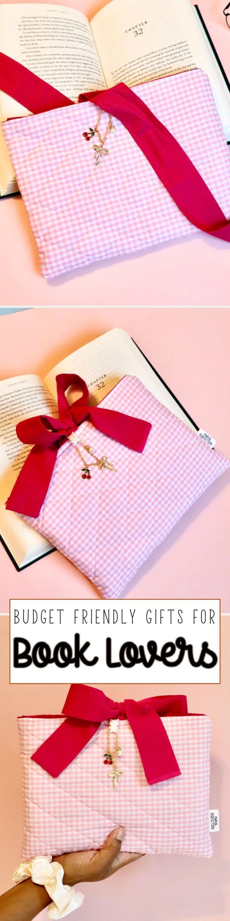 May include: A pink and white gingham book sleeve with a red ribbon and a gold cherry charm necklace. The book sleeve is open, revealing pages from a book. The text "BUDGET FRIENDLY GIFTS FOR BOOK LOVERS" is at the bottom.