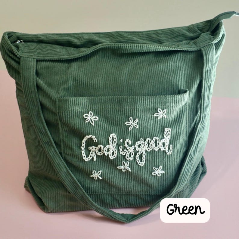 Faith-inspired green corduroy Bible tote bag with secure zipper and front pocket. Handmade embroidery adds a personalized touch, perfect for church, Bible study, or Sunday school. Stylish, functional tote bag for women who want to carry their devotion, gift for Christian women, and Bible accessory for daily inspiration. Hand embroidered fall tote bag with flower design. Embroidered Bible bag with pocket. Teen Girl gift idea, teen girl tote bag for book lover floral tote bag. totebag with zipper.