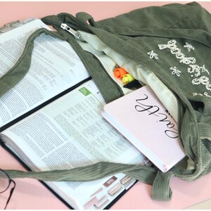 Stylish Christian corduroy tote bag with zipper and large front pocket, handmade with premium embroidered detailing that reads “Faith Over Fear.” Perfect as a women’s church bag, Bible study tote, or everyday Christian work bag. Designed for modern believers seeking functional, faith-based accessories that express style and devotion. Ideal faith gift for her, Christian birthday gift, or baptism present.