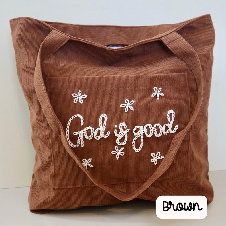 Handmade brown corduroy church tote bag with zipper closure and large front pocket. Embroidered scripture design perfect for Bible study, Sunday school, or daily Christian use. Stylish, durable, and functional tote for women seeking faith-inspired gifts, Bible carrying bag, or personalized Christian accessory for everyday inspiration. Chain Stitch Tote Bag custom embroidered to read God is Good.