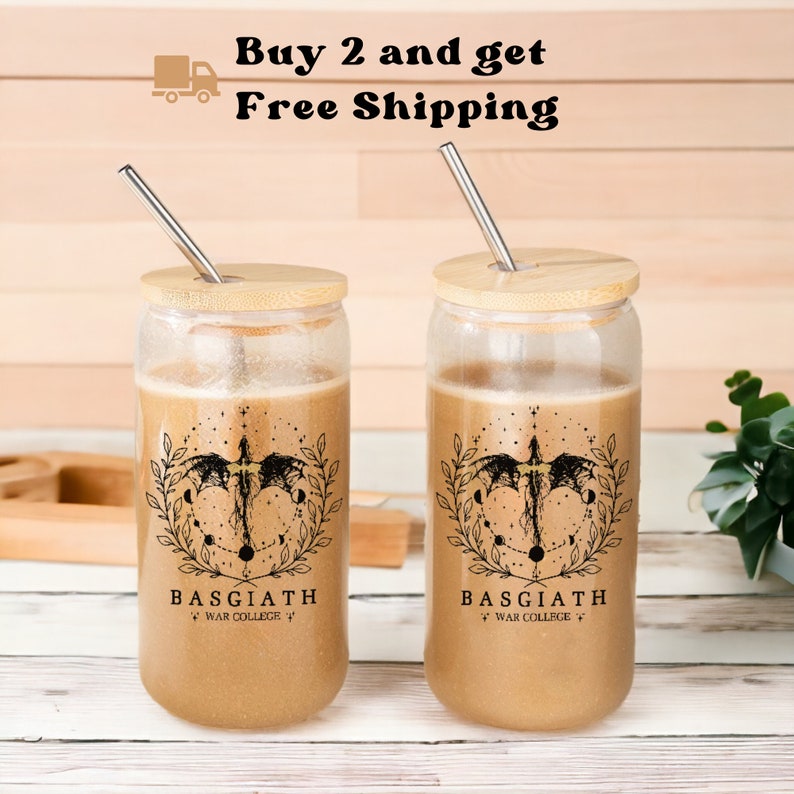 May include: Two clear glass tumblers with bamboo lids and stainless steel straws. Each tumbler features a black and white graphic of a dragon with a celestial design and the text "Basgiath War College".