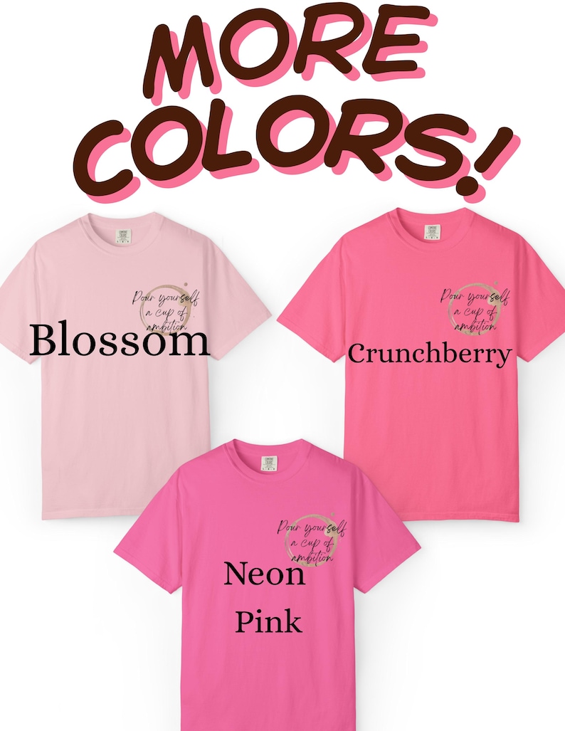 May include: Three short-sleeve t-shirts in shades of light pink, medium pink, and neon pink. Each shirt features a small graphic on the left chest with a coffee ring stain and the text "Pour yourself a cup of ambition." Text labels read "Blossom," "Crunchberry," and "Neon Pink."