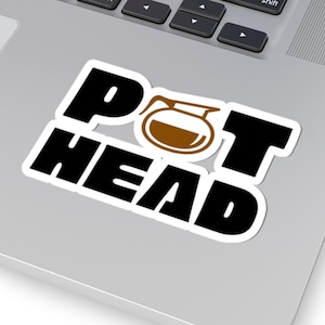 May include: A white sticker with black text that reads "POT HEAD" with a brown coffee pot icon in the middle of the text.