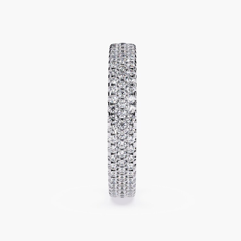 White gold eternity band with 3 rows of small diamonds around the band.