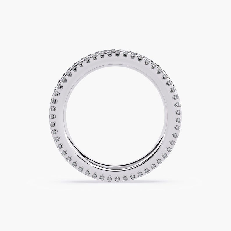 White gold eternity band with 3 rows of small diamonds around the band.