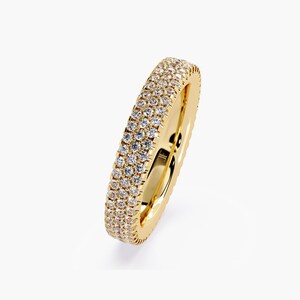 Yellow gold eternity band with 3 rows of small diamonds around the band.