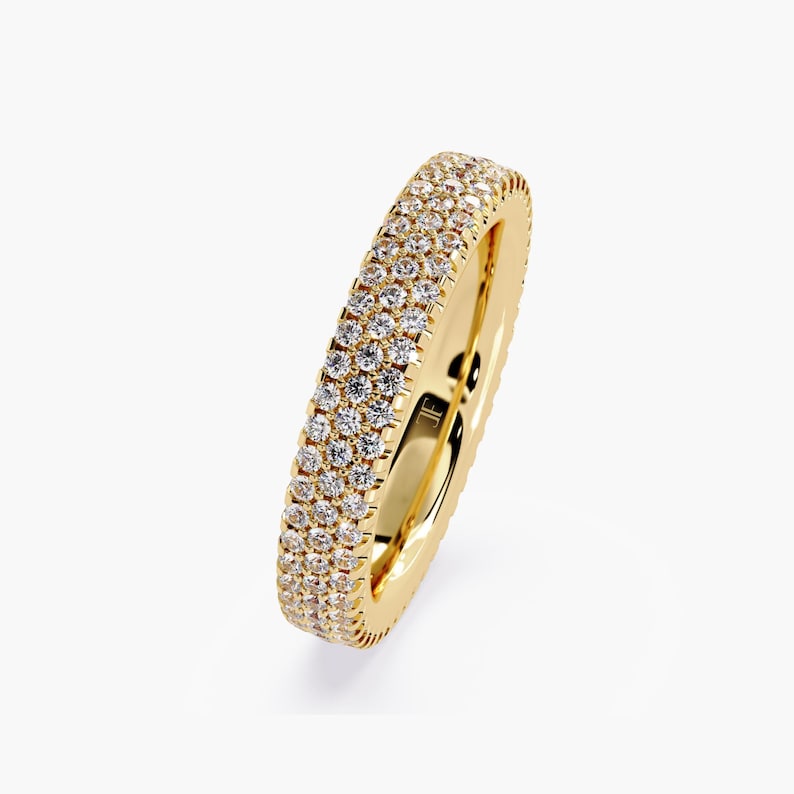 Yellow gold eternity band with 3 rows of small diamonds around the band.