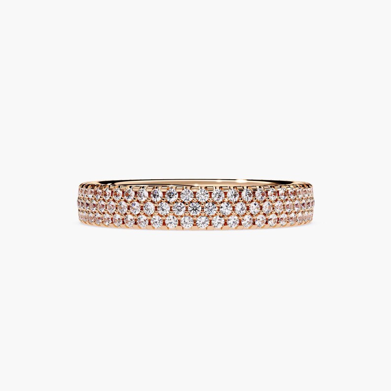 Rose gold eternity band with 3 rows of small diamonds around the band.