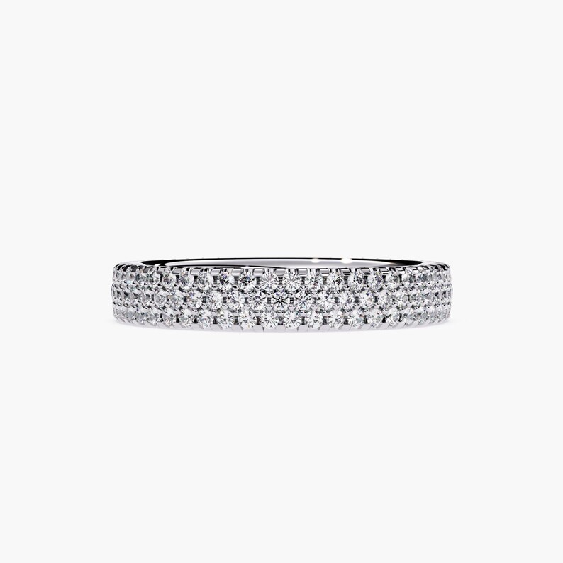 White gold eternity band with 3 rows of small diamonds around the band.