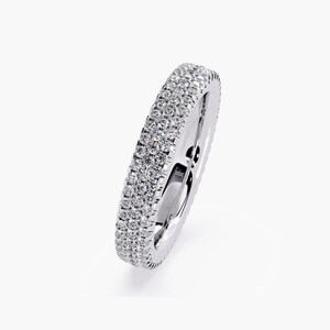 White gold eternity band with 3 rows of small diamonds around the band.
