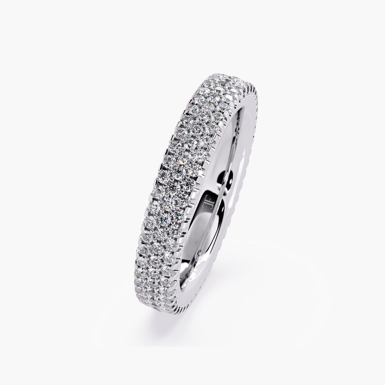 White gold eternity band with 3 rows of small diamonds around the band.