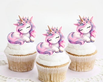 May include: Three cupcakes decorated with pink and purple unicorn toppers. Each topper features a white unicorn with a pink and purple mane and tail, a gold horn, and a flower crown.