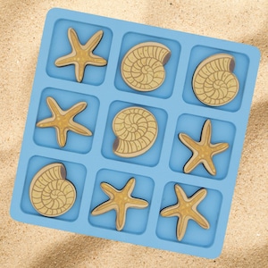 May include: A blue wooden game board with nine squares. Each square has a cutout for a wooden tile. The tiles are either a starfish or a nautilus shell. The tiles are yellow and brown.