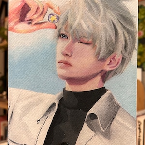 May include: A watercolour portrait of a person with silver hair and blue eyes, winking. The person wears a white jacket over a black turtleneck. A hand holds a small, round object with a star design.