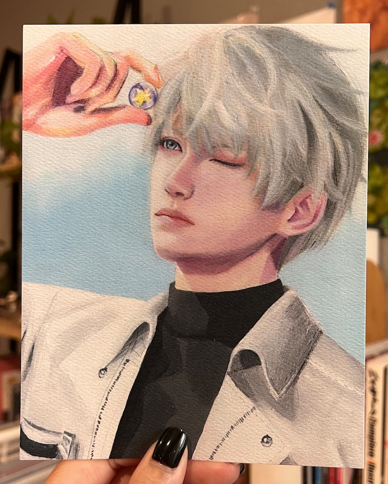 May include: A watercolour portrait of a person with silver hair and blue eyes, winking. The person wears a white jacket over a black turtleneck. A hand holds a small, round object with a star design.